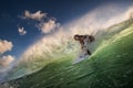 A surfer riding on green ocean wave