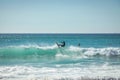 Surfer riding a surfboard on a large set of waves in an ocean