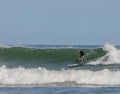 Surfer riding on the surfboards on the foamy waves of the ocean during the daytime in Chilmark