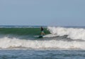 Surfer riding on the surfboards on the foamy waves of the ocean during the daytime in Chilmark