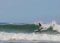 Surfer riding on the surfboards on the foamy waves of the ocean during the daytime in Chilmark