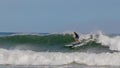 Surfer riding on the surfboards on the foamy waves of the ocean during the daytime in Chilmark