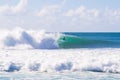 A surfer riding a wave in Waimea Beach