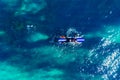 Surfer rows up to catch crest of wave in blue ocean. Concept surfing. Top view Royalty Free Stock Photo