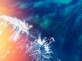 Surfer rows up to catch crest of wave in blue ocean sunlight. Concept surfing. Top view Royalty Free Stock Photo