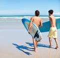 Surfer, running and rear view of men friends at a beach with freedom, energy or fun. Back, fitness and surfing people at