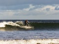 Surfer scene in Moray, Scotland, United Kingdom.