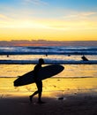 Surfer silhouette beach sunset Bali Royalty Free Stock Photo