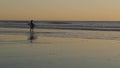 Surfer silhouette, pacific ocean beach sunset. People enjoy surfing. Oceanside, California USA Royalty Free Stock Photo