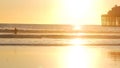 Surfer silhouette, pacific ocean beach sunset. People enjoy surfing. Oceanside, California USA