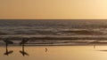 Surfer silhouette, pacific ocean beach sunset. People enjoy surfing. Oceanside, California USA Royalty Free Stock Photo