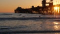 Surfer silhouette, pacific ocean beach sunset. People enjoy surfing. Oceanside, California USA Royalty Free Stock Photo