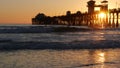 Surfer silhouette, pacific ocean beach sunset. People enjoy surfing. Oceanside, California USA