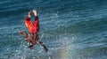 Surfer splashed by wave