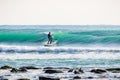 Surfer on stand up paddle board on blue wave. SUP surfing in ocean Royalty Free Stock Photo