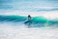 Surfer on stand up paddle board on wave. Winter surfing in ocean Royalty Free Stock Photo