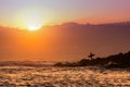 Silhouette of a surfer at sunrise or sunset Royalty Free Stock Photo