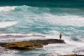 Surfer standing on a rock Royalty Free Stock Photo