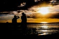 Surfer at sunset on a calm ocean Royalty Free Stock Photo