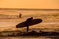 Surfer at sunset on a calm ocean