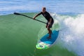 Surfer SUP Riding Wave Royalty Free Stock Photo