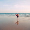 Surfer with surf board on ocean beach Royalty Free Stock Photo