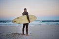 Surfer, surfboard and senior man on beach at sea waves in during sunset during summer vacation in Hawaii. Professional