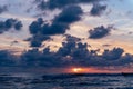 Surfer surfing at the vivid color of the North Sea sunset Royalty Free Stock Photo