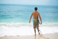 Surfer. Surfing Man With Surfboard Walking On Sandy tropical Beach. Healthy Lifestyle, water activities, Water Sport. Beautiful Royalty Free Stock Photo