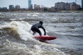 A surfer surfing on a standing wave in the rapids of the Ottawa River