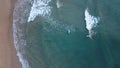 Surfers in the surf waiting for waves in the turquoise ocean off the Victorian Coastline Royalty Free Stock Photo