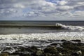 Surfer surfs a perfect wave on a sunny day