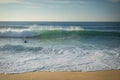 Surfer swimming breaking wave coming to shore on sandy beach of atlantic coast, capbreton, france Royalty Free Stock Photo