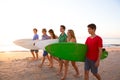 Surfer teen boys girls group walking on beach