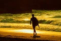 Surfer walking on the beach Royalty Free Stock Photo