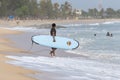 Surfer walking on the beach