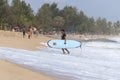 Surfer walking out of the sea