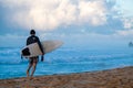 Surfer walks along the beach Royalty Free Stock Photo