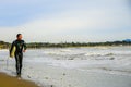 Surfer walks the Beach in the Morning Royalty Free Stock Photo