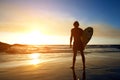 Surfer watching sunset on the beach Royalty Free Stock Photo