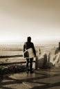 California. USA. October 2012. A surfer watching the waves at sunset.