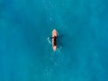 Surfer top of wave in ocean, top view aeria