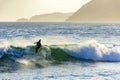 Surfer in the wave at sunset