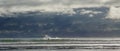 Surfer on waves in dramatic seascape