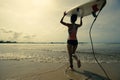 surfer with white surfboard walking to the sea Royalty Free Stock Photo