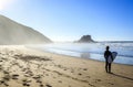 Surfer on wild beach in western Portugal