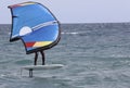surfer in windfoil sailing through the waves. Royalty Free Stock Photo