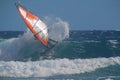 Surfer windsurfing in the waves, performing a cutback with spray Royalty Free Stock Photo