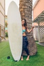 Surfer woman with bikini and wetsuit holding Royalty Free Stock Photo