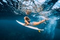 Surfer woman dive underwater. Surfgirl dive under wave